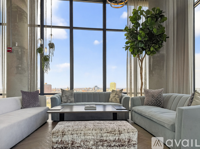 A living room with a large window overlooking the city.