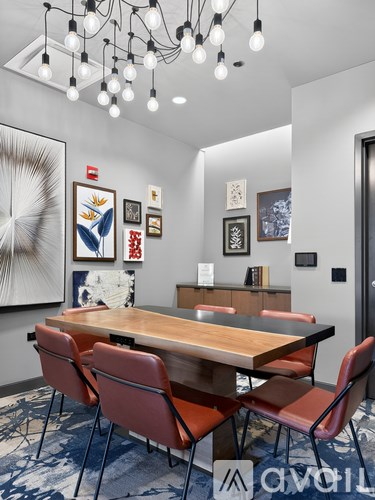 A conference room with a long table and chairs.