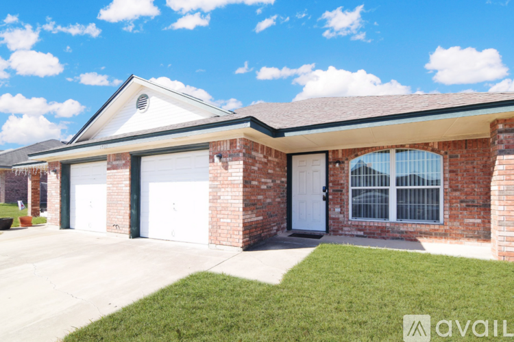A house with a brick facade and a white garage door.