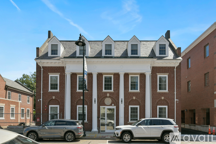 A large red brick building with a white trim and a black roof.