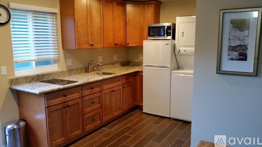 A kitchen with wooden cabinets and a white refrigerator.