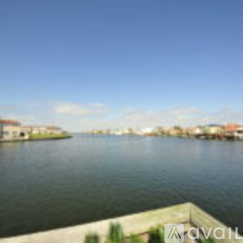 A body of water with a building in the distance.