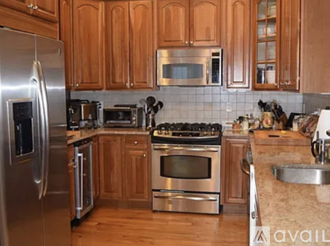 A kitchen with wooden cabinets and stainless steel appliances.