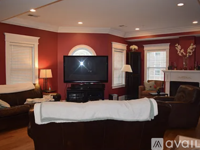 A living room with a large couch and a television.