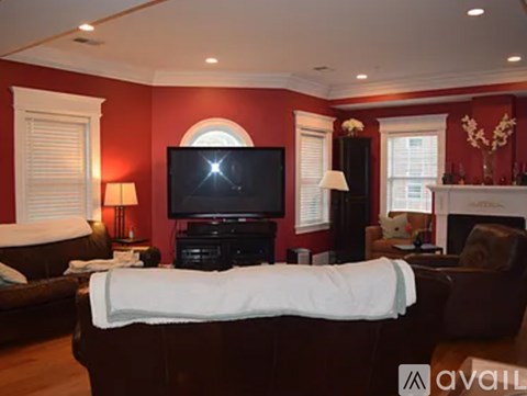 A living room with a large couch and a television.