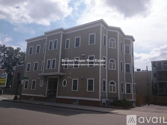 A multi-story building with the text "Boston Proper Real Estate" and a website address on it.