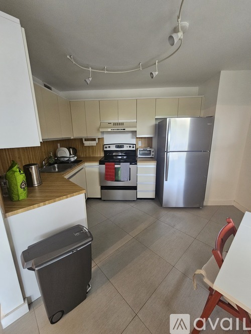 A kitchen with a refrigerator, stove, and oven.