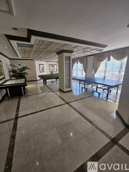 A spacious room with a billiard table and a pool table.
