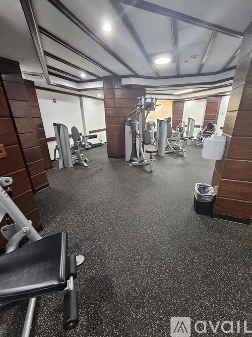 A gym with a variety of equipment including weights and machines.
