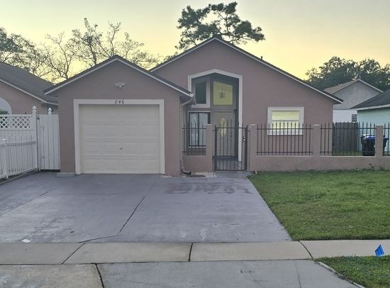 A house with a garage is for sale.