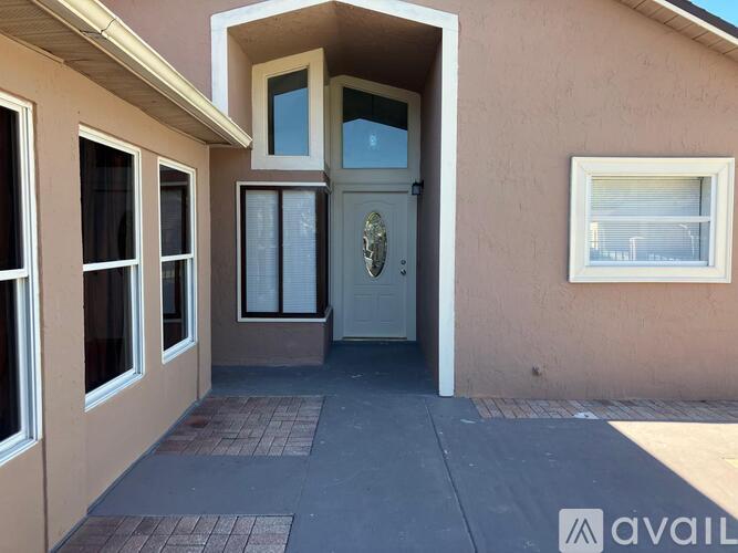 A house with a white door and windows is available for rent.