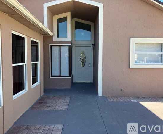A house with a white door and windows is available for rent.