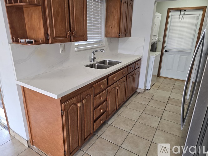 A kitchen with wooden cabinets and a white countertop.