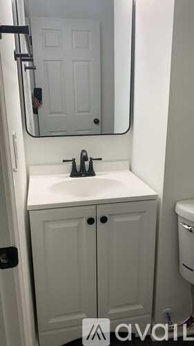 A white bathroom with a sink and toilet.