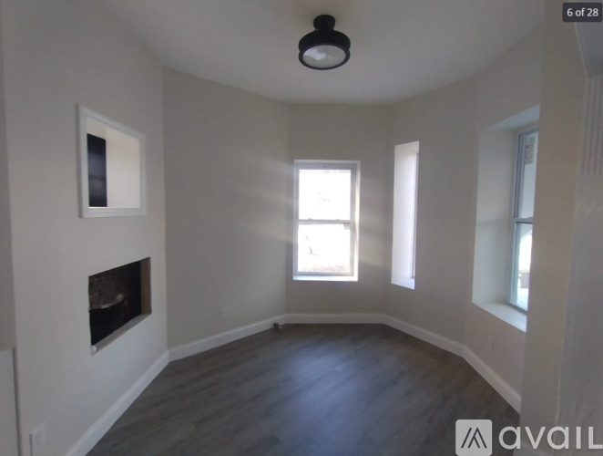A room with a fireplace and a window.
