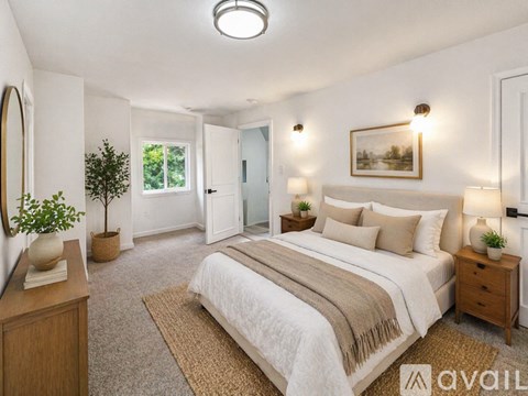 A room with wooden flooring and a window with blinds.