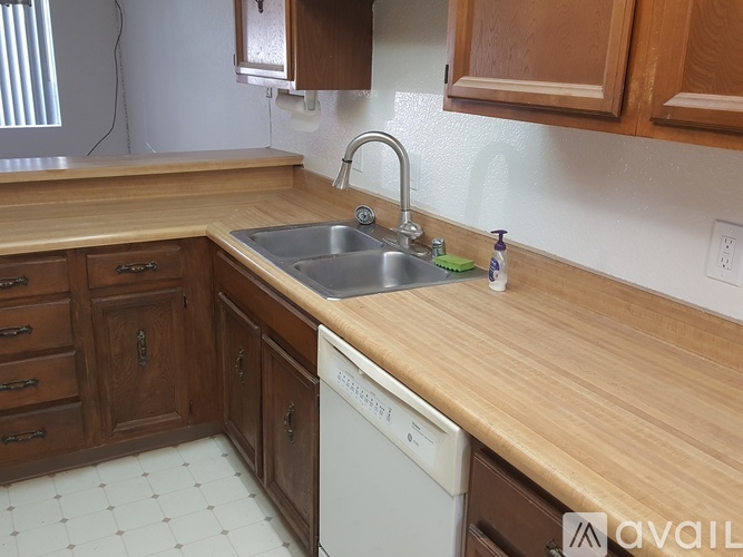A kitchen with wooden cabinets and a white door.