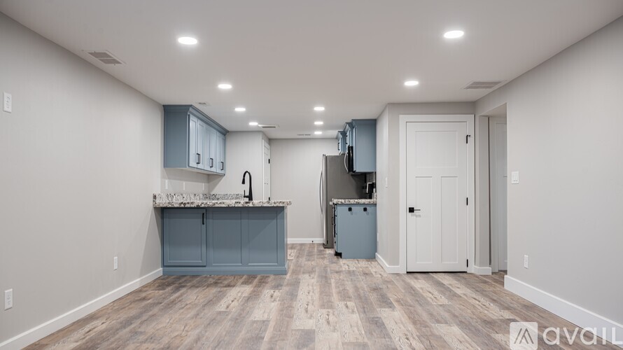 A kitchen area with a counter and cabinets.