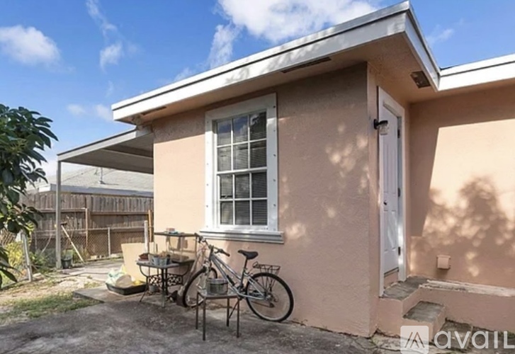 A small house with a bicycle parked in front.