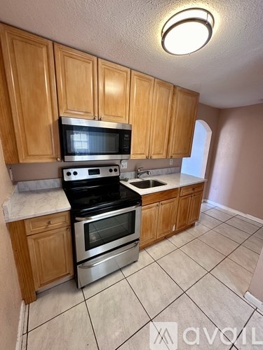 A kitchen with wooden cabinets and stainless steel appliances.