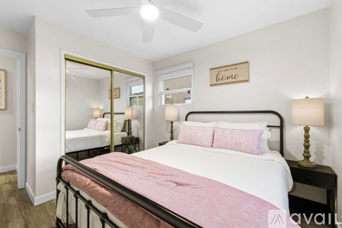 A bedroom with a large bed and a mirror on the wall.