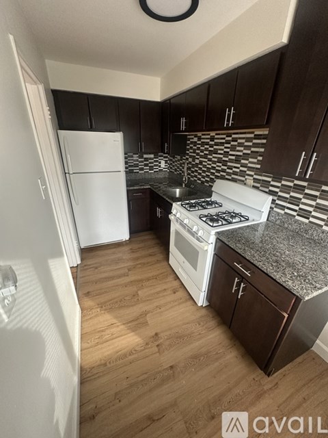 A kitchen with a white fridge and a white stove top oven.