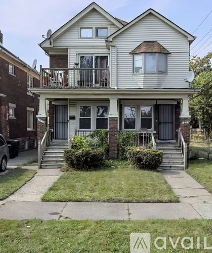 A two-story house with a balcony on the second floor.