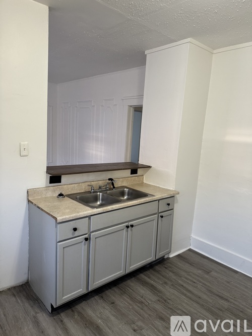 A kitchen with a sink and cabinets.