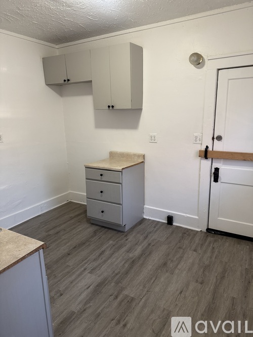 A room with a dresser and a cabinet.