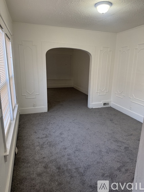 A room with white walls and a carpeted floor.