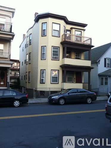 A two-story building with a balcony on the second floor.