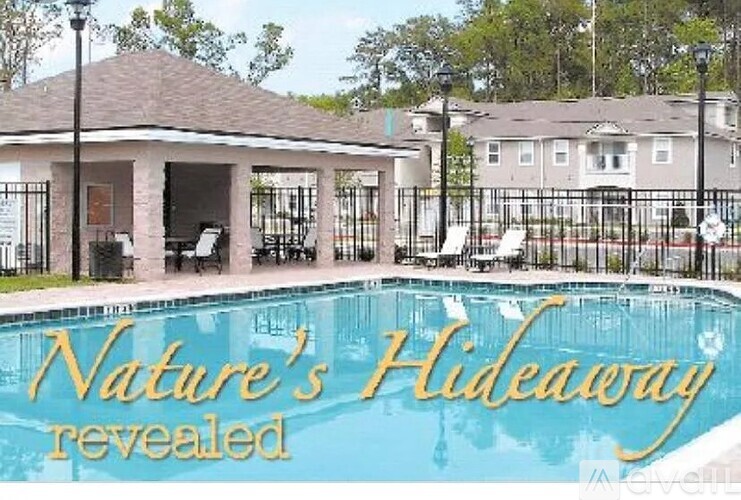 A pool with the words Nature's Hideaway revealed written on it.