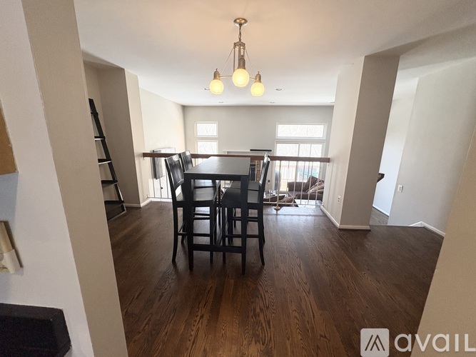 A dining room with a table and chairs.