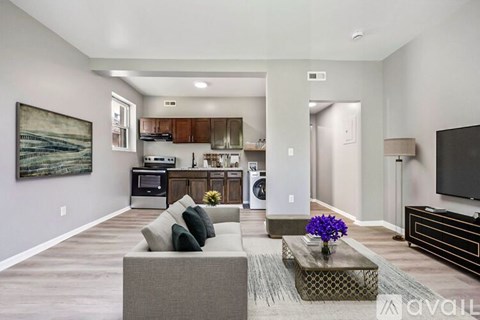 A modern living room with a grey couch and a coffee table.
