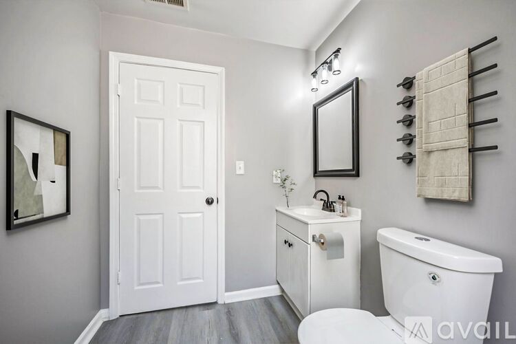 A white bathroom with a toilet, sink, and tub.