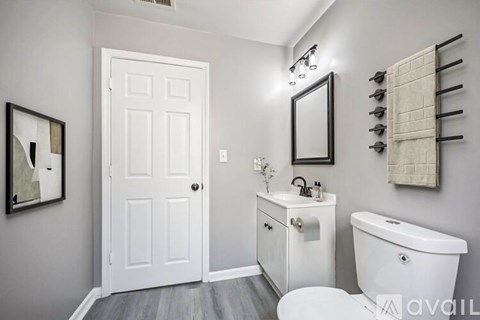A white bathroom with a toilet, sink, and tub.