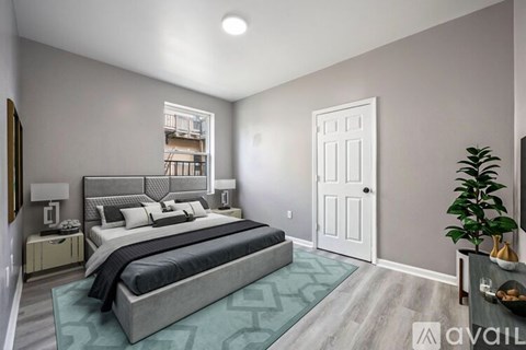 A bedroom with a large bed and a plant on the side table.