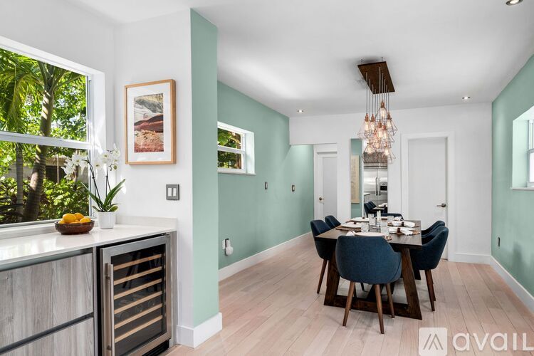 A dining room with a table set for six people.