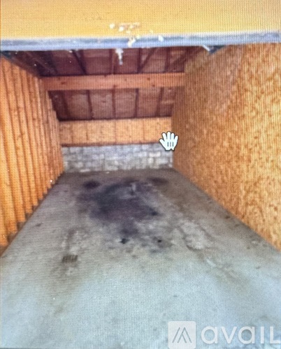 A dirty basement with a concrete floor and orange walls.
