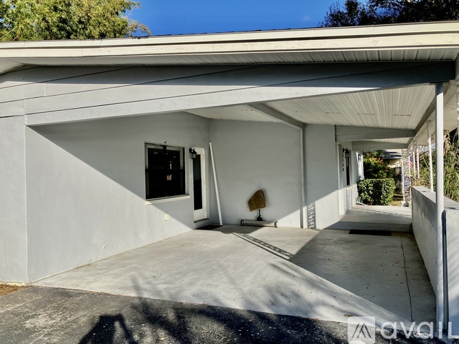 A modern house with a white exterior and a covered patio area.
