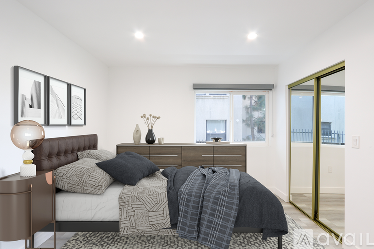 A bedroom with a bed, nightstand, and lamp.