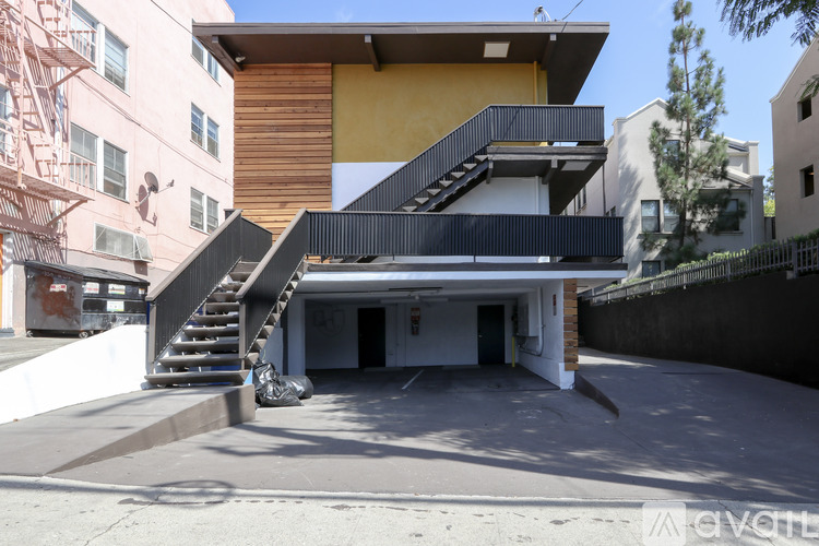 A modern house with a garage and stairs leading to the entrance.