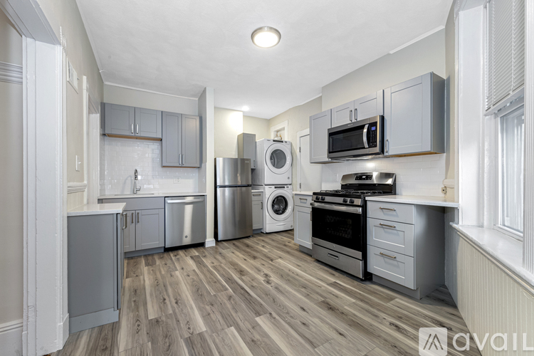 A kitchen with a washing machine and a dishwasher.