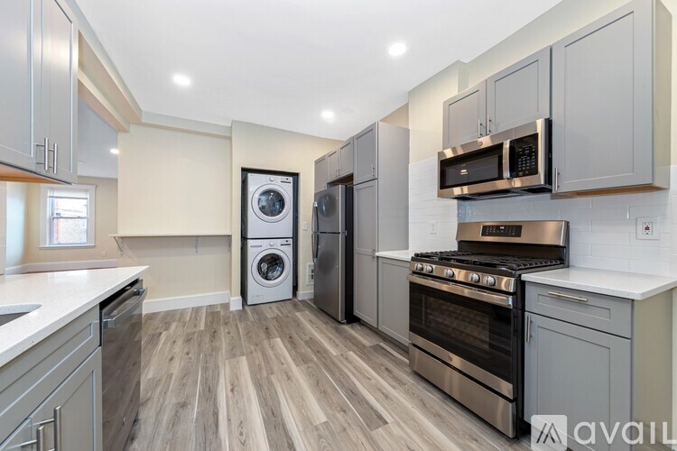 A modern kitchen with a washing machine and a stove.