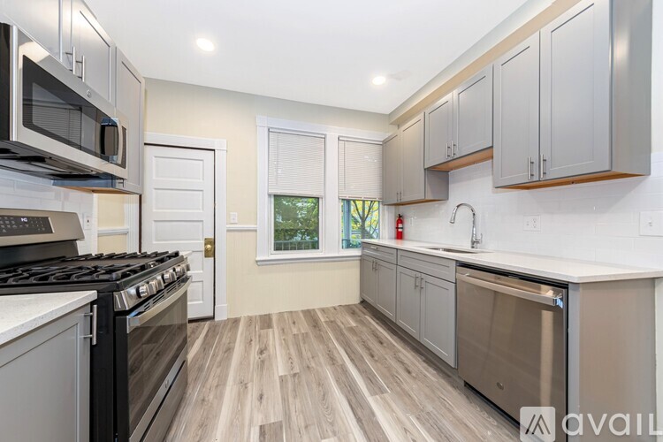 A kitchen with a stove top oven and a dishwasher.