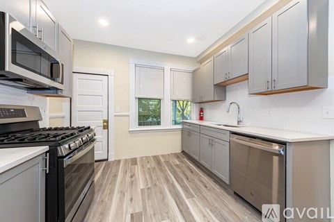 A kitchen with a stove top oven and a dishwasher.