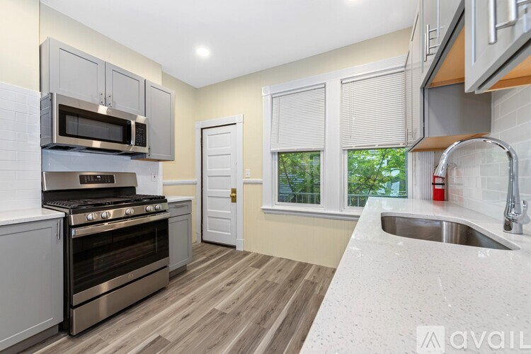 A kitchen with a stove, oven, and sink.