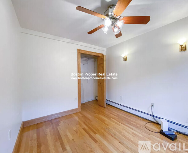 A room with wooden floors and a ceiling fan.