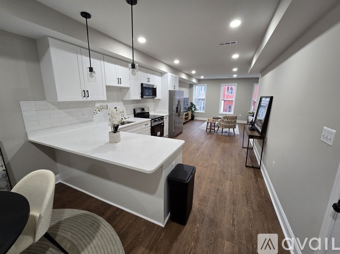 A modern kitchen with white cabinets and a large island.
