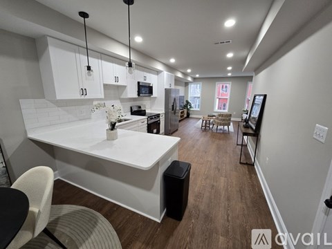 A modern kitchen with white cabinets and a large island.
